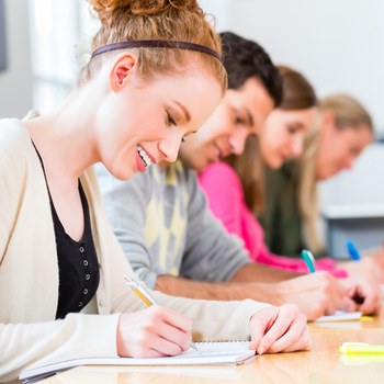 Students studying and writing at desks